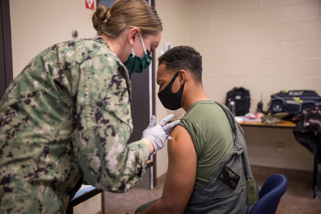 U.S. Marines stationed on Marine Corps Air Station (MCAS) Yuma, receive their COVID-19 vaccination on MCAS Yuma, Ariz., Feb. 16, 2021. Vaccines are being administered in phased approach, prioritizing healthcare workers and first responders, as well as mission critical and deploying personnel. The vaccine is voluntary and Marines are receiving it in order to keep the Corps mission ready. (U.S. Marine Corps photo by Lance Cpl John Hall)