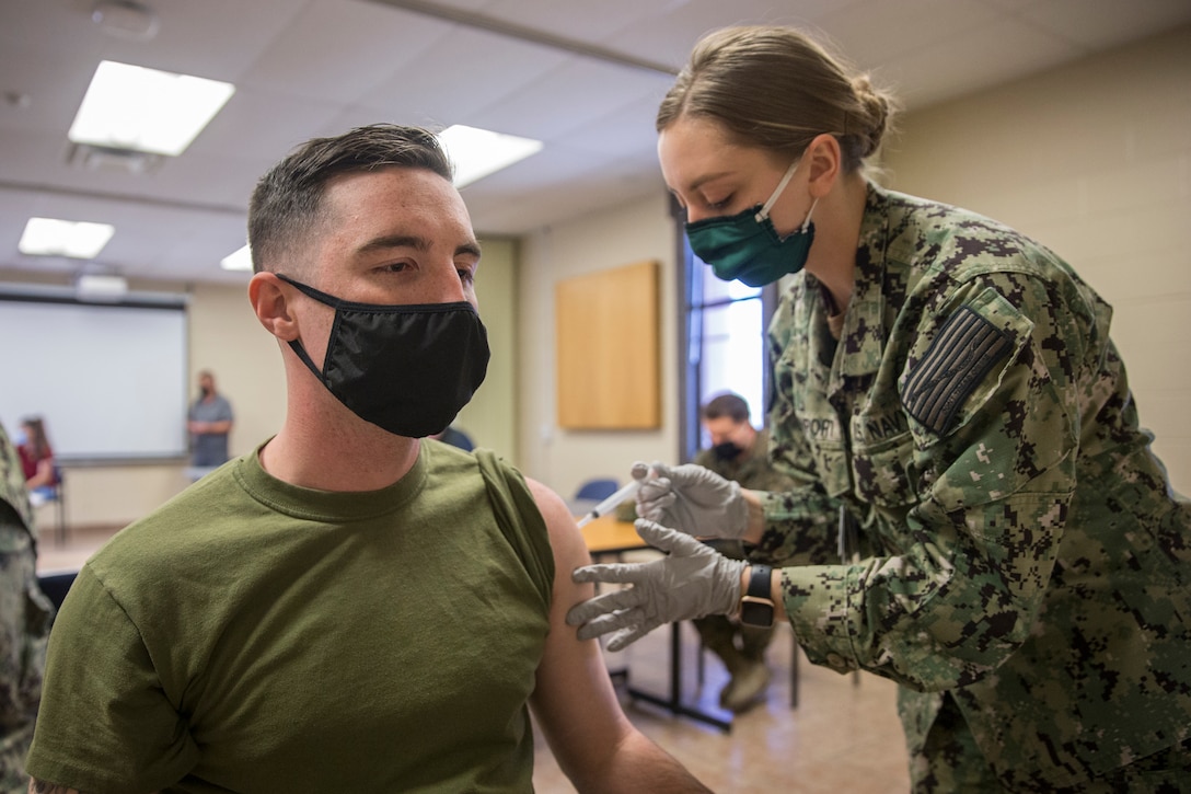 U.S. Marines stationed on Marine Corps Air Station (MCAS) Yuma, receive their COVID-19 vaccination on MCAS Yuma, Ariz., Feb. 16, 2021. Vaccines are being administered in phased approach, prioritizing healthcare workers and first responders, as well as mission critical and deploying personnel. The vaccine is voluntary and Marines are receiving it in order to keep the Corps mission ready. (U.S. Marine Corps photo by Lance Cpl John Hall)