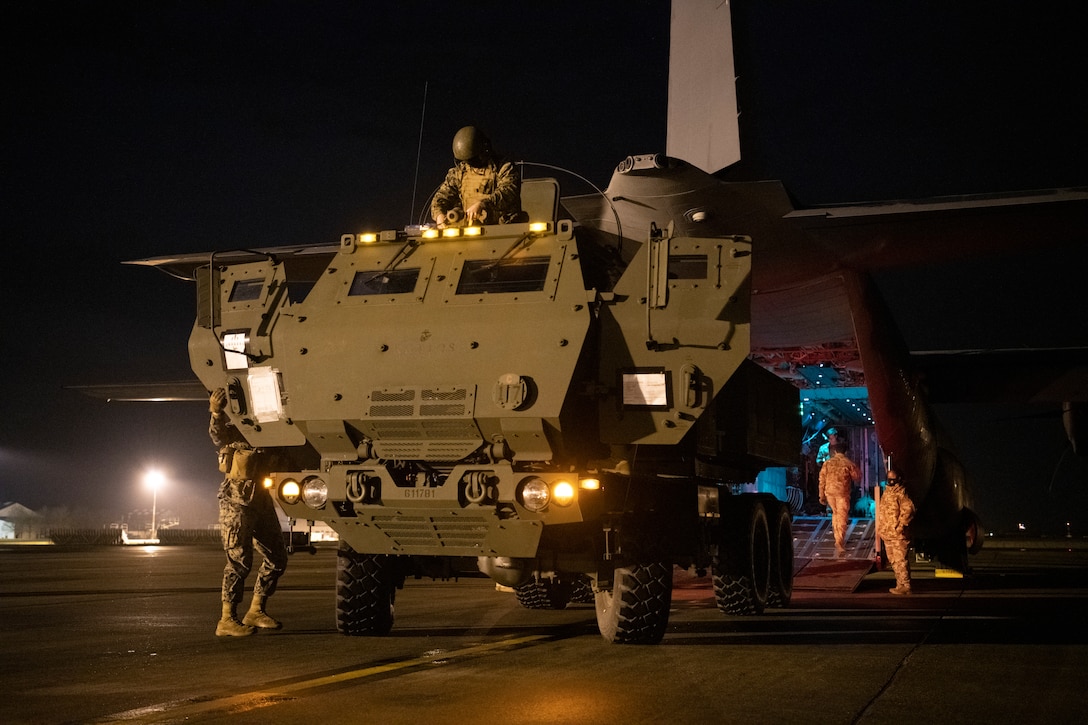 Marines from the 24th Marine Expeditionary Unit and loadmasters assigned to 352d Special Operations Wing prepare to on-load a High Mobility Artillery Rocket System (HIMARS) onto an MC-130J Commando II at RAF Mildenhall on March 25, 2021 during low-visibility, night training. Special operation’s capabilities enhance the execution of HIMARS Rapid Aerial Insertion missions, extend the reach of long-range, precision strike capabilities and enable the joint force. (U.S. Air Force photo by Master Sgt. Roidan Carlson)