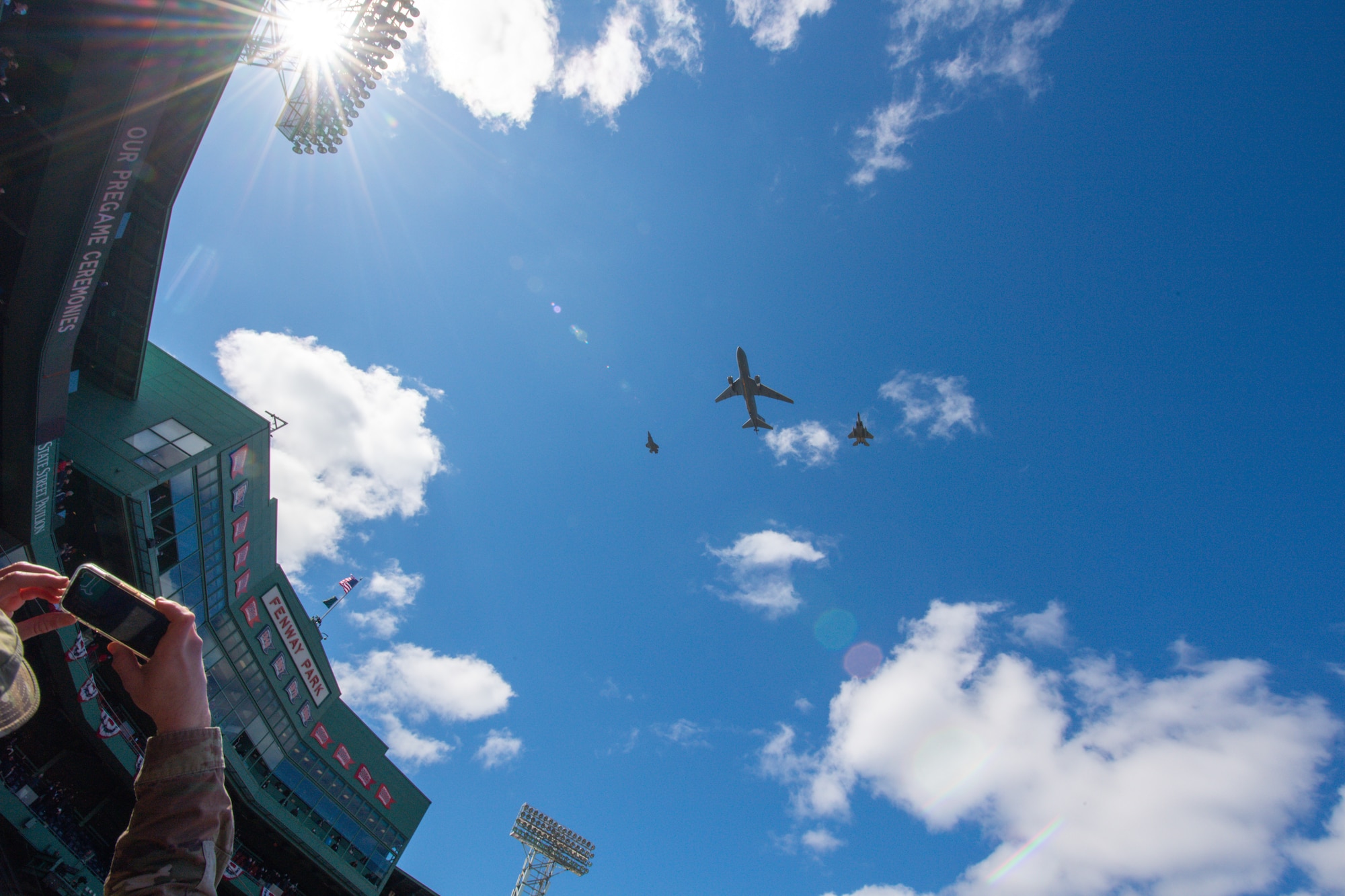 An F-35A Lightning II assigned to the Vermont Air National Guard joins a KC-46 Pegasus assigned to Pease Air National Guard and an F-15 Eagle assigned to Barnes Air National Guard for a flyover tribute during the Boston Red Sox 2021 season home opener at Fenway Park.