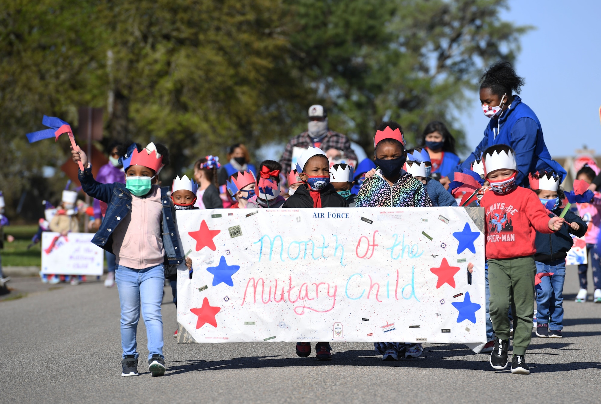 Children of Keesler personnel participate during a parade in front of the child development center at Keesler Air Force Base, Mississippi, April 1, 2021. The event was held in celebration of the Month of the Military Child, which is recognized throughout the month of April. (U.S. Air Force photo by Kemberly Groue)