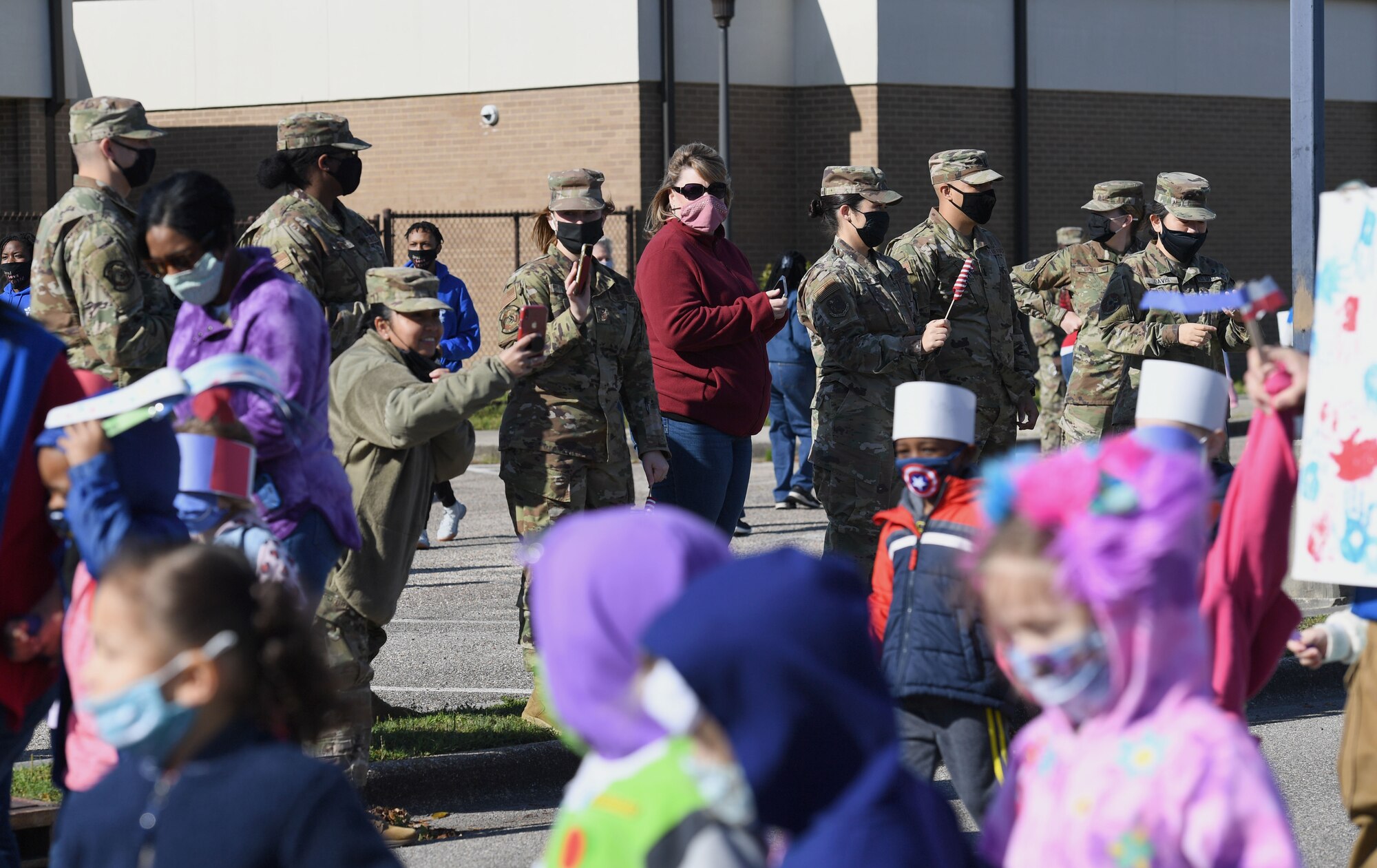Keesler personnel attend a children's parade in front of the child development center at Keesler Air Force Base, Mississippi, April 1, 2021. The event was held in celebration of the Month of the Military Child, which is recognized throughout the month of April. (U.S. Air Force photo by Kemberly Groue)