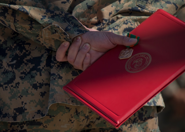 U.S. Navy Hospital Corpsman Third Class Randall Lambert holds a Navy and Marine Achievement Medal at Cannon Air Defense Complex in Yuma Ariz. Mar 5 2021. The Navy and Marine Achievement Medal is awarded for superior performance of a service member's duties. ( U.S. Marine Corps photo by Lance Cpl. Carlos Kealy)