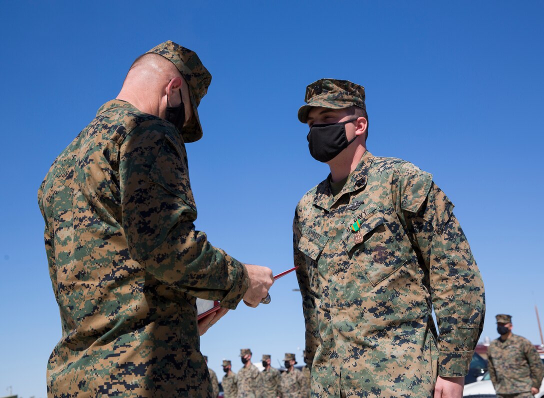 U.S. Marine Corps Lieutenant Colonel Nicholas Lozar reads award warrant for U.S. Navy Hospital Corpsman Third Class (HM3) Randall Lambert at Cannon Air Defense Complex in Yuma Ariz. Mar 5 2021. The Navy and Marine Achievement Medal is awarded for superior performance of a service member's duties. ( U.S. Marine Corps photo by Lance Cpl. Matthew Romonoyske-Bean)