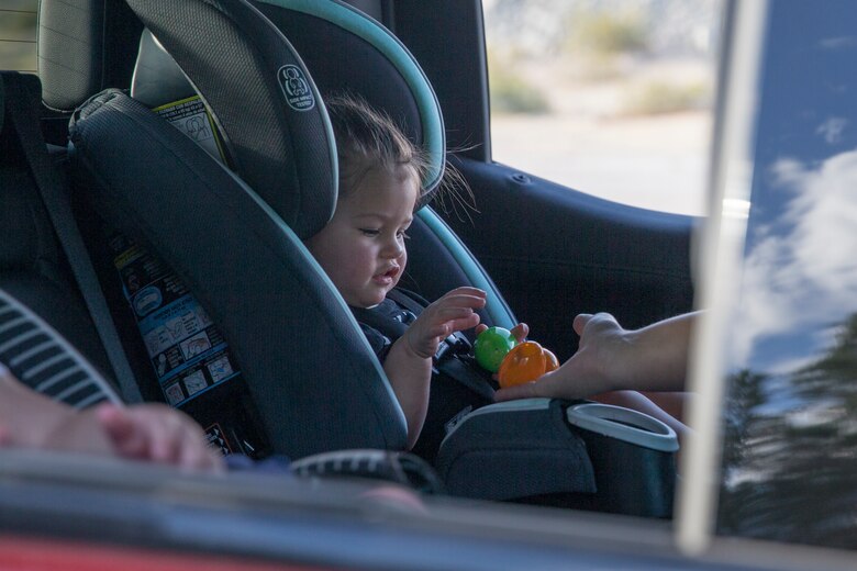 A child collects eggs during the Easter Eggstravaganza on Marine Corps Air Station Yuma, April 1, 2021. The drive-through event allowed military children and their families a chance to participate in the excitement of gathering eggs, toys and candy. (U.S. Marine Corps photo by Sgt. Nicole Rogge)