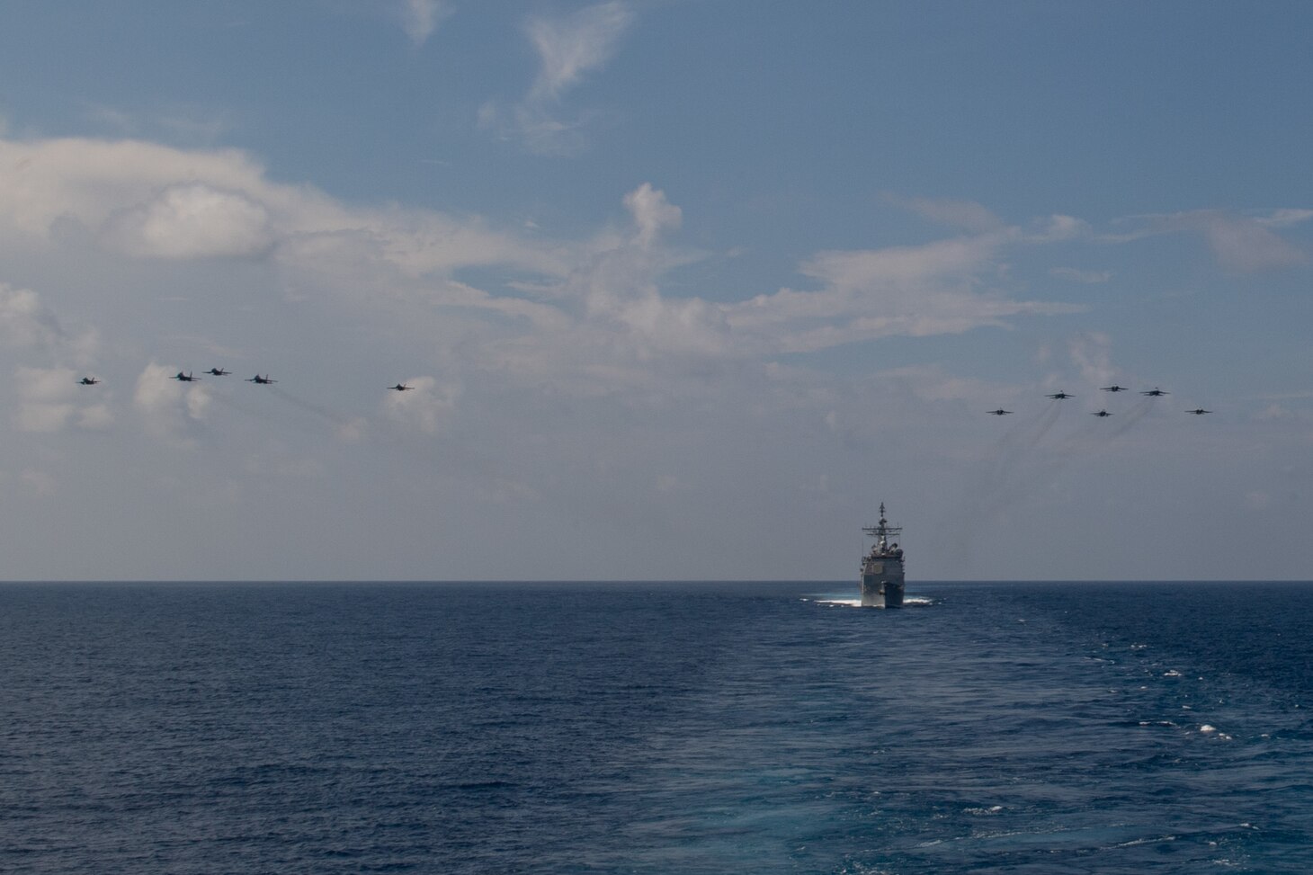 Aircraft from Carrier Air Wing (CVW) 11 and the Royal Malaysian Air Force (RMAF) fly above the Ticonderoga-class guided-missile cruiser USS Bunker Hill (CG 52) April 7, 2021. The Theodore Roosevelt Carrier Strike Group is on a scheduled deployment to the U.S. 7th Fleet area of operations. As the U.S. Navy’s largest forward-deployed fleet, 7th Fleet routinely operates and interacts with 35 maritime nations while conducting missions to preserve and protect a free and open Indo-Pacific Region.