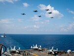 Aircraft from Carrier Air Wing (CVW) 11 and the Royal Malaysian Air Force (RMAF) fly above the aircraft carrier USS Theodore Roosevelt (CVN 71) April 7, 2021. The Theodore Roosevelt Carrier Strike Group is on a scheduled deployment to the U.S. 7th Fleet area of operations. As the U.S. Navy’s largest forward-deployed fleet, 7th Fleet routinely operates and interacts with 35 maritime nations while conducting missions to preserve and protect a free and open Indo-Pacific Region.
