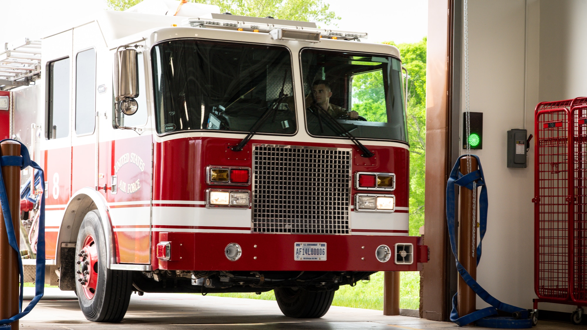 Senior Airman Tristen Frey, 2nd Civil Engineer Squadron firefighter, drives a fire truck into the newly opened Fire Station Two truck bay at Barksdale Air Force Base, Louisiana, April 7, 2021.