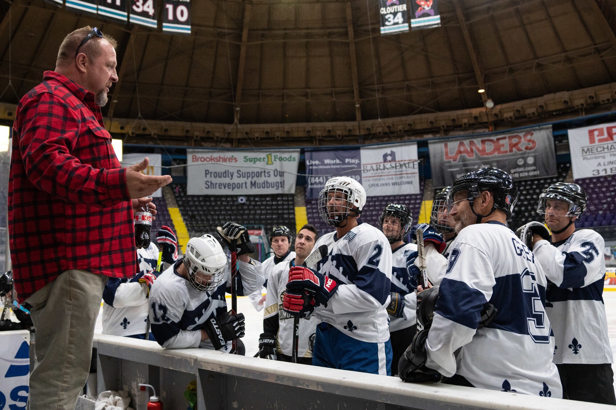 Airmen from the Barksdale Bombers hockey team from Barksdale Air Force Base, Louisiana, have a pre-game huddle before the Mudbugs Adult Hockey League championship game at the Hirsch Memorial Coliseum in Shreveport, Louisiana, March 31, 2021.