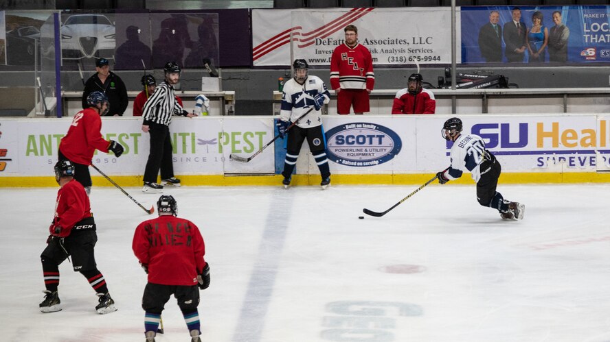 An Airman from the Barksdale Bombers hockey team from Barksdale Air Force Base, Louisiana, prepares to maneuver through opposing players during the Mudbugs Adult Hockey League championship game at Hirsch Memorial Coliseum, Shreveport, Louisiana, March 31, 2021.