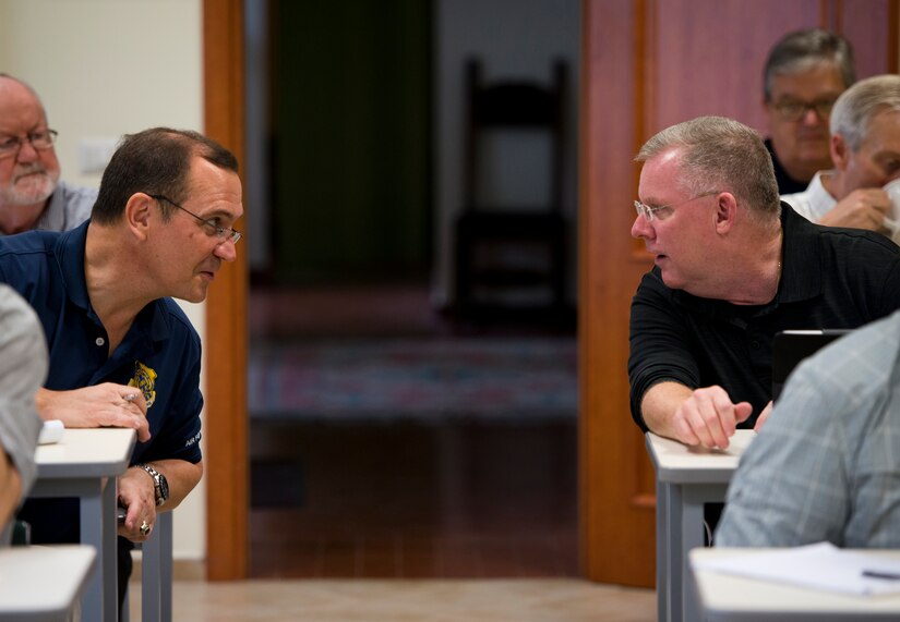 Retired Chaplains (Lt. Col.) Stephen Voyt (left) and (Lt. Col.) Kerry Abbott finish their conversations before class starts.  (U.S. Air Force photo/Staff Sgt. Andrew Lee)