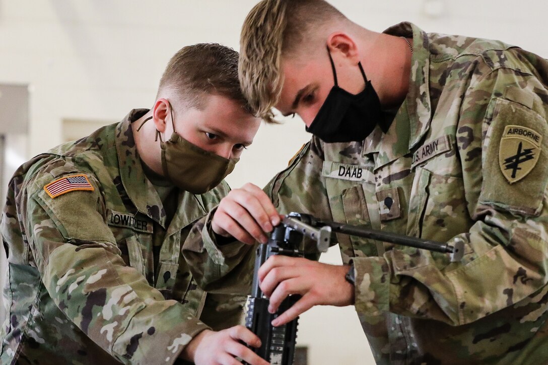 U.S. Army Reserve Spc. Timothy Lowitzer, left, a civil affairs specialist with the 1001st Civil Affairs and Psychological Operations Company, and Spc. Daab Jackson, a civil affairs specialist with the 492nd Civil Affairs Battalion, assemble an M249 squad automatic weapon during the first day of the 2021 U.S. Army Civil Affairs and Psychological Operations Command (Airborne) Best Warrior Competition at Fort Jackson, S.C., April 7, 2021. The USACAPOC(A) BWC is an annual competition that brings in the best Soldiers across USACAPOC(A) to earn the title of “Best Warrior.” BWC tests the Soldiers’ individual ability to adapt and overcome challenging scenarios and battle-focused events, testing their technical and tactical skills under stress and extreme fatigue.