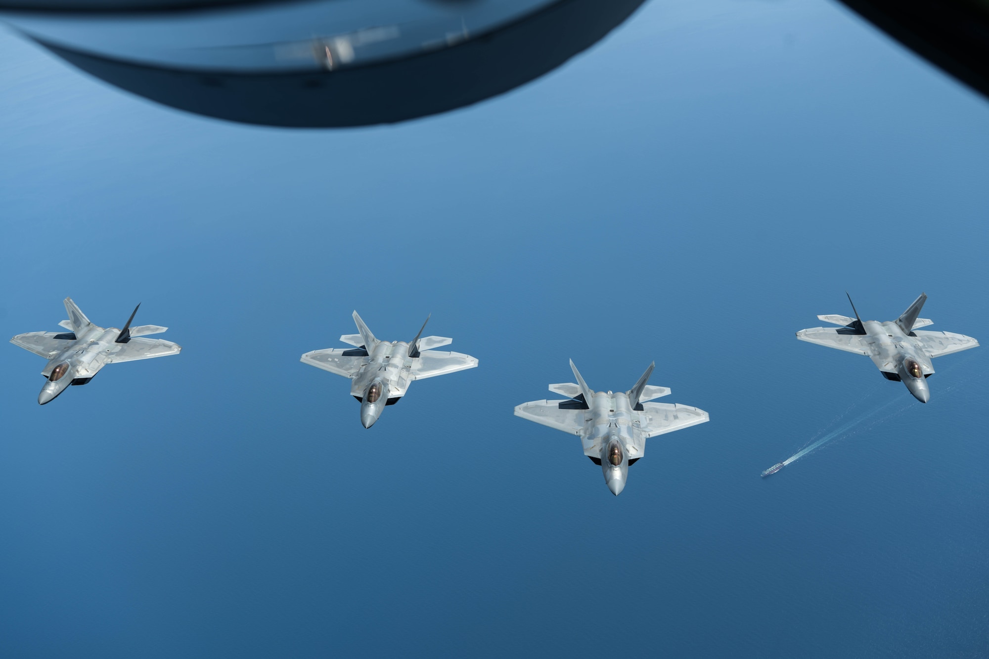 U.S. Air Force F-22 Raptors from the 199th Fighter Squadron, Joint Base Pearl Harbor-Hickam, Hawaii, fly in formation during a bilateral operation, April 1, 2021. The 199th Fighter Squadron deployed to Marine Corps Air Station Iwakuni, Japan, to conduct integrated training with Marine and Naval forces as part of U.S. Indo-Pacific Command’s dynamic force employment concept. (U.S. Air Force photo by Senior Airman Rebeckah Medeiros)