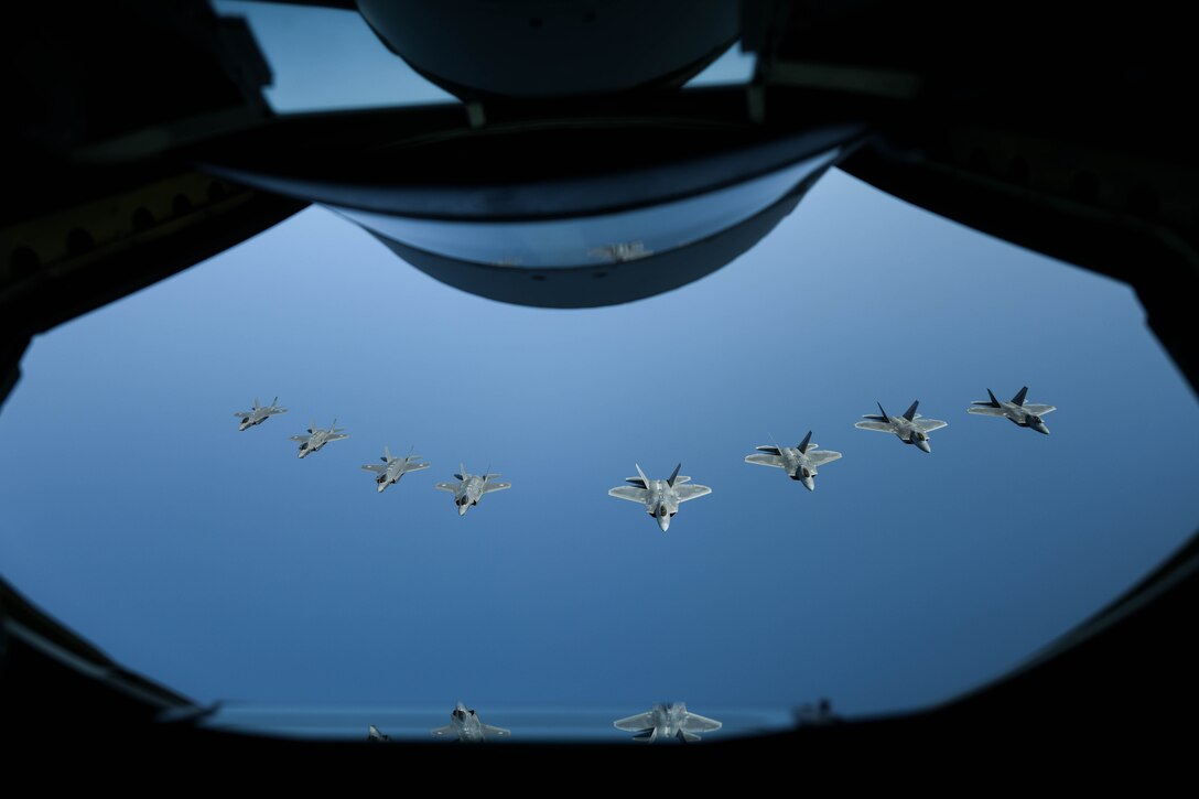U.S. Air Force F-22 Raptors from the 199th Fighter Squadron and Japan Air Self-Defense Force F-35A Lightning II aircraft from the 302nd Tactical Fighter Squadron fly alongside a U.S. Air Force KC-135 Stratotanker from the 909th Air Refueling Squadron during 5th generation fighter training near Japan, April 1, 2021. The F-22 Raptors are currently operating out of Marine Corps Air Station Iwakuni, Japan, to support U.S. Indo-Pacific Command’s dynamic force employment concept. U.S. and Japanese forces train and operate together regularly, employing a full spectrum of joint and bilateral capabilities, to defend Japan and support a secure and stable Indo-Pacific region. (U.S. Air Force photo by Senior Airman Rebeckah Medeiros)