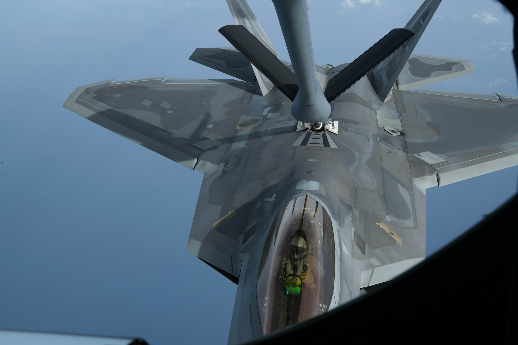 A U.S. Air Force F-22 Raptor, from the 199th Fighter Squadron, approaches a KC-135 Stratotanker, from the 909th Air Refueling Squadron, for refueling during a 5th generation fighter operation near Japan, April 1, 2021. The F-22 Raptors are currently operating out of Marine Corps Air Station Iwakuni, Japan, to support U.S. Indo-Pacific Command’s dynamic force employment concept. (U.S. Air Force photo by Senior Airman Rebeckah Medeiros)