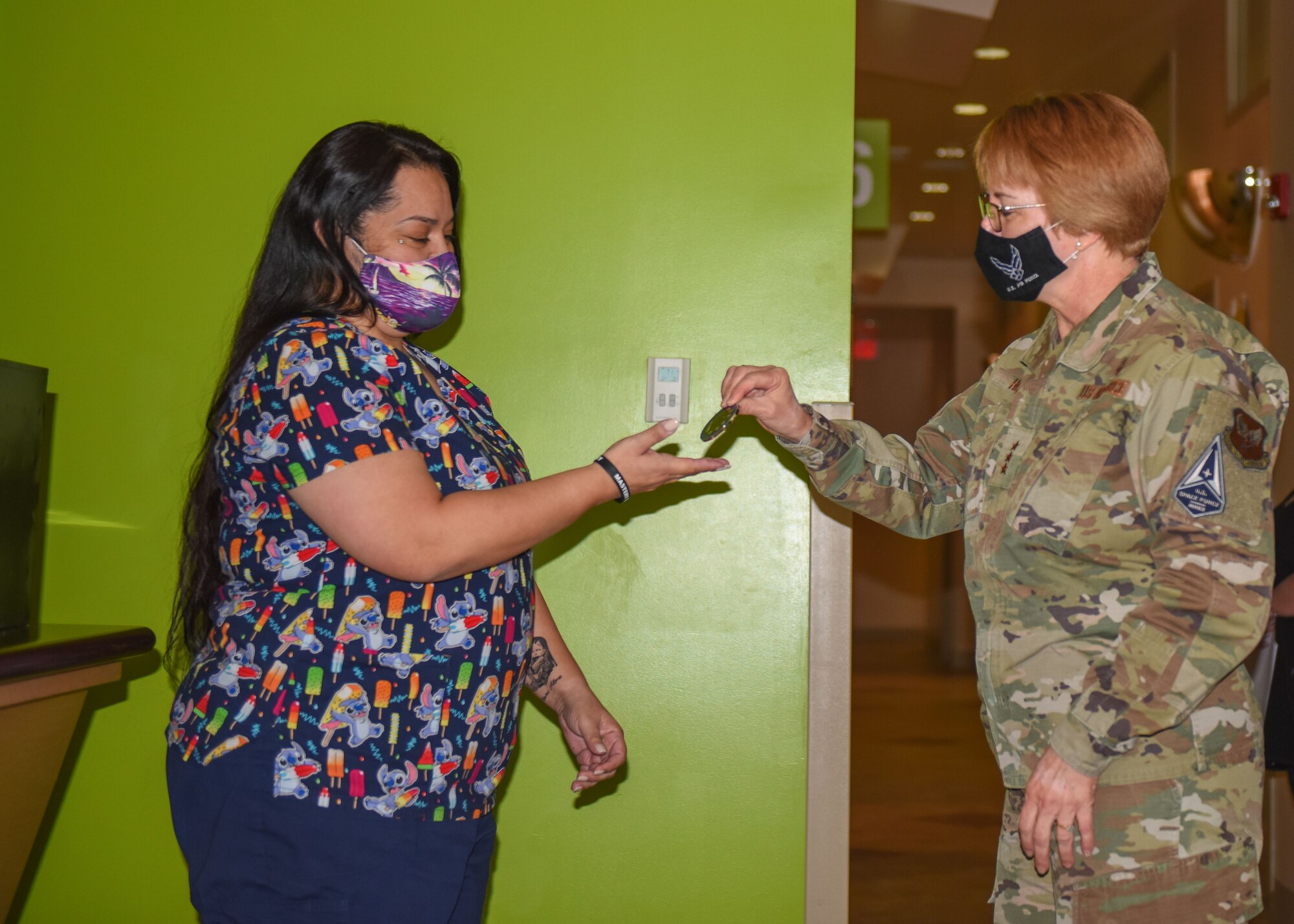 General gives a coin to civilian worker