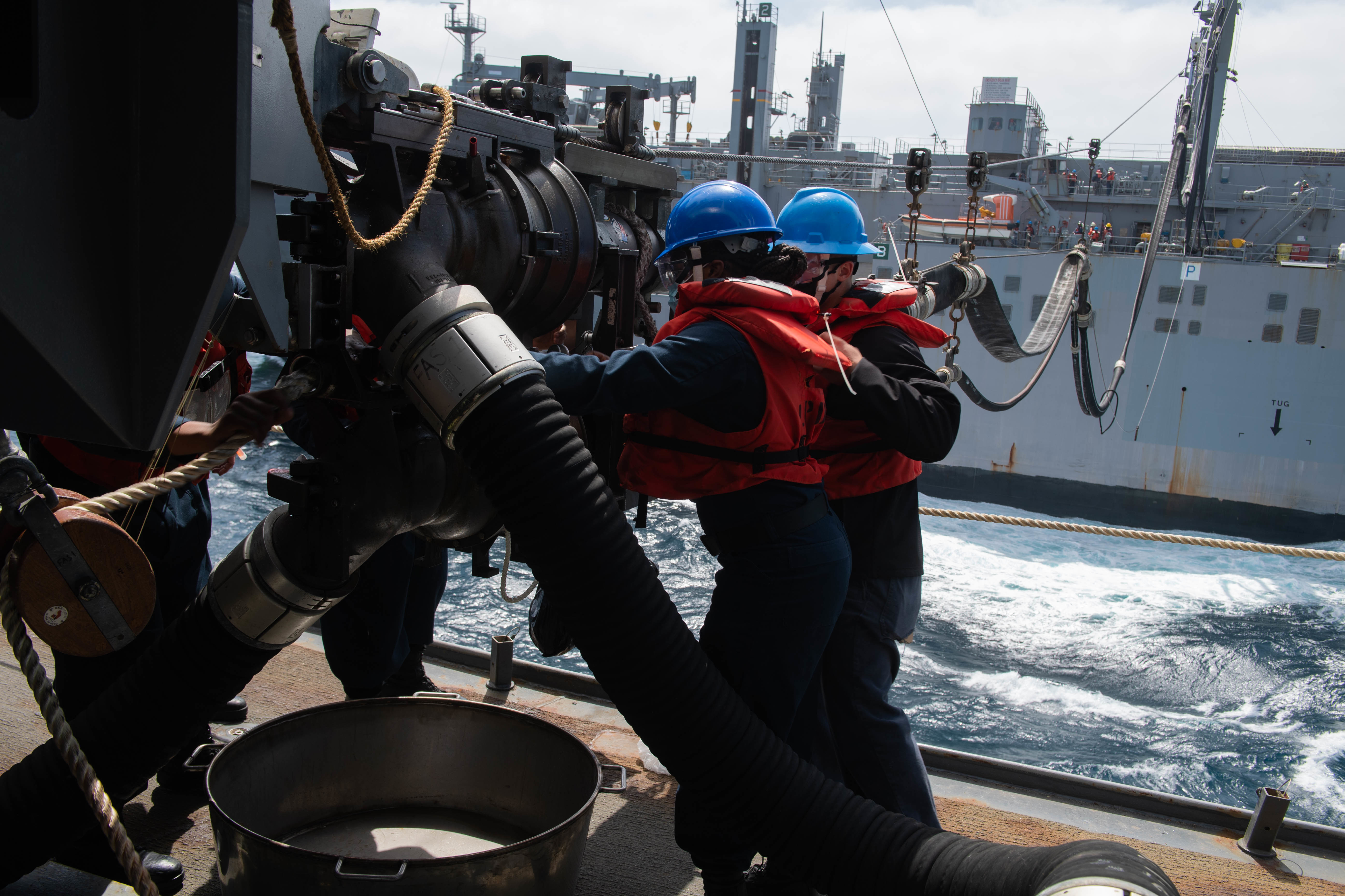 Sailors assigned to San Antonio-class amphibious transport dock USS Portland (LPD 27) prepare for a planned emergency breakaway during a replenishment-at-sea with Lewis and Clark-class dry cargo ship USNS Richard E. Byrd (T-AKE 4).