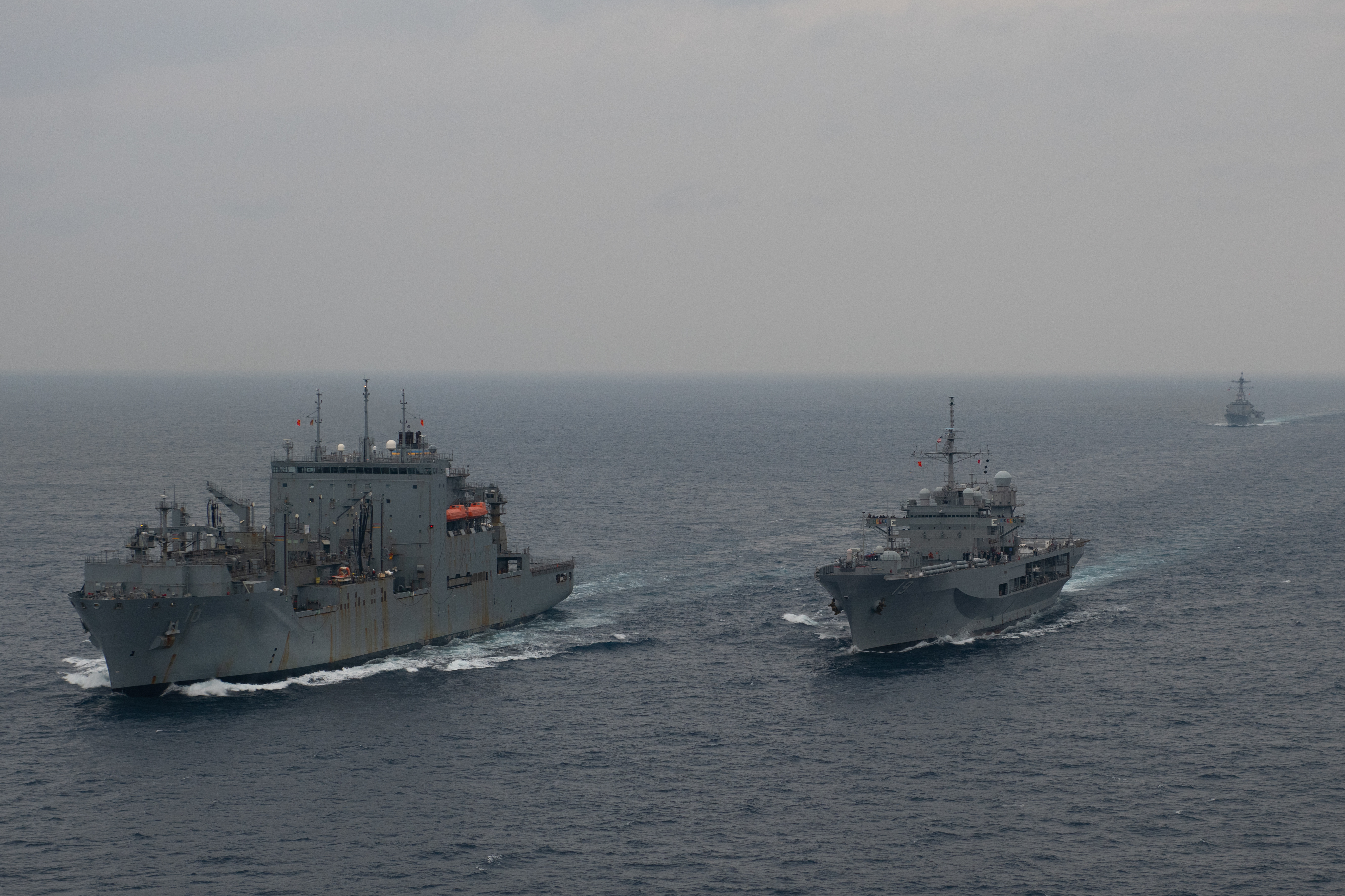 U.S. 7th Fleet flagship USS Blue Ridge (LCC 19) executes an underway replenishment (UNREP) in the East China Sea with the Military Sealift Command dry cargo and ammunition ship USNS Charles Drew (T-AKE 10), left, as Arleigh Burke-class guided-missile destroyer USS Mustin (DDG 89) approaches.