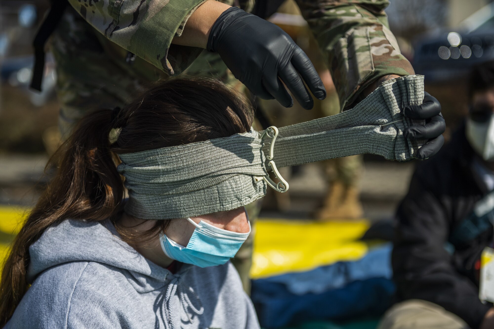 A volunteer for the 52nd Fighter Wing Medical Group exercise Ready EAGLE receives simulated medical attention at Spangdahlem Air Base, Germany, March 26, 2021. The training event at the MDG lasted the entire week and culminated in a capstone event, which simulated a disaster at the base theater. (U.S. Air Force photo by Senior Airman Ali Stewart)