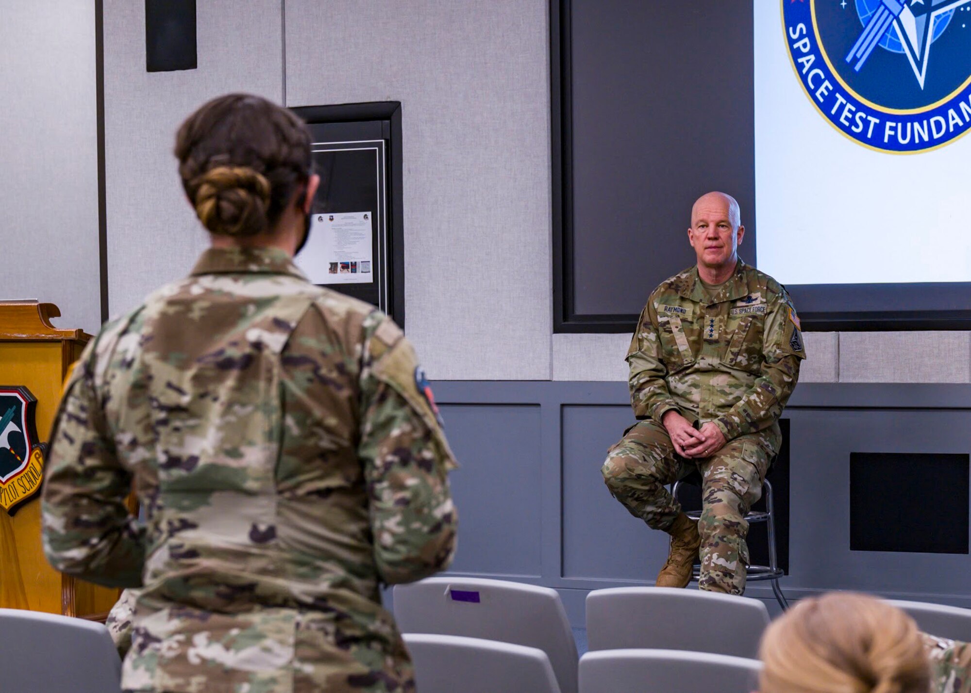 United States Space Force Gen. John W. “Jay” Raymond, Chief of Space Operations, responds to a question from Spc. 4 Haley Roll, Space Test Fundamentals Class 21-1 student, at Edwards Air Force Base, California, April 6. (Air Force photo by Giancarlo Casem)