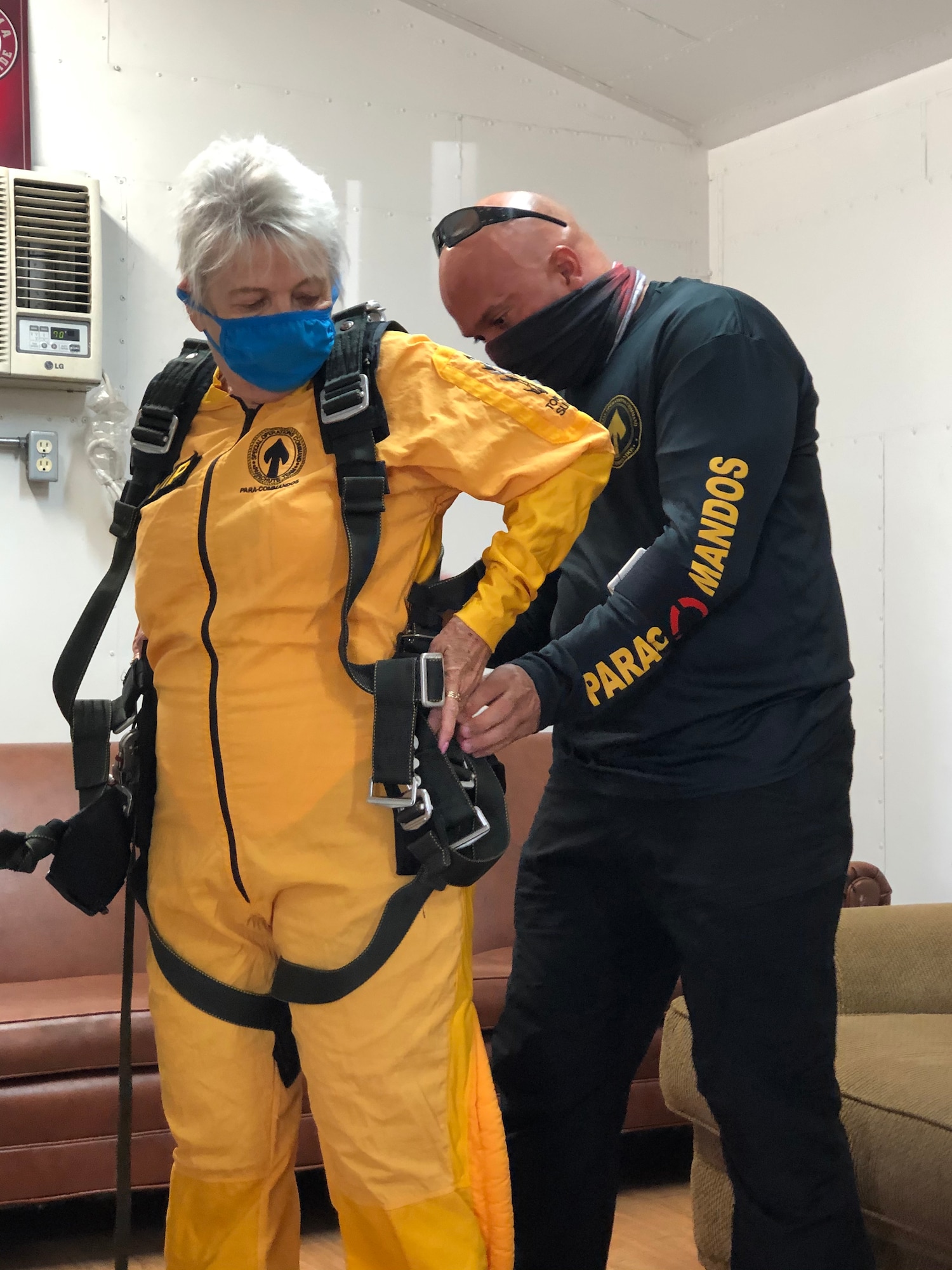Sandee Rouse, Gold Star mother, and Army Sgt. Maj. Jose Vazquez, Special Operations Command Para-Commando, connect a tandem harness before a skydive March 13, 2021.