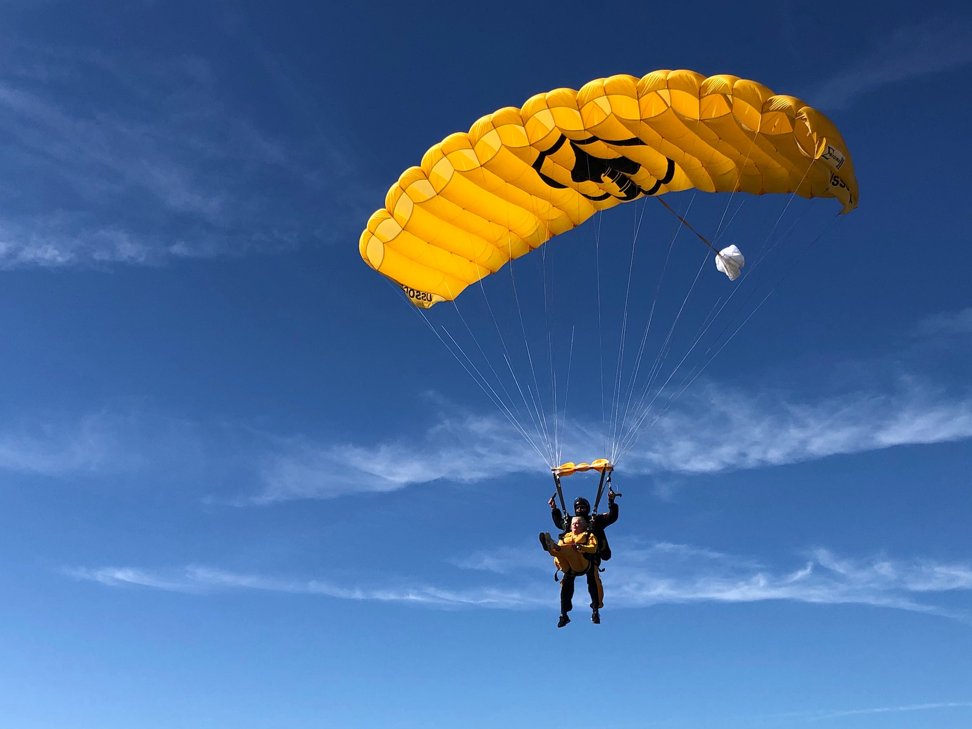 Ellen Comfort and Army Lt. Col. Ken Ates, Special Operations Command Para-Commando, prepare to land after a skydive March 13, 2021, in Zephyrhills, Florida.