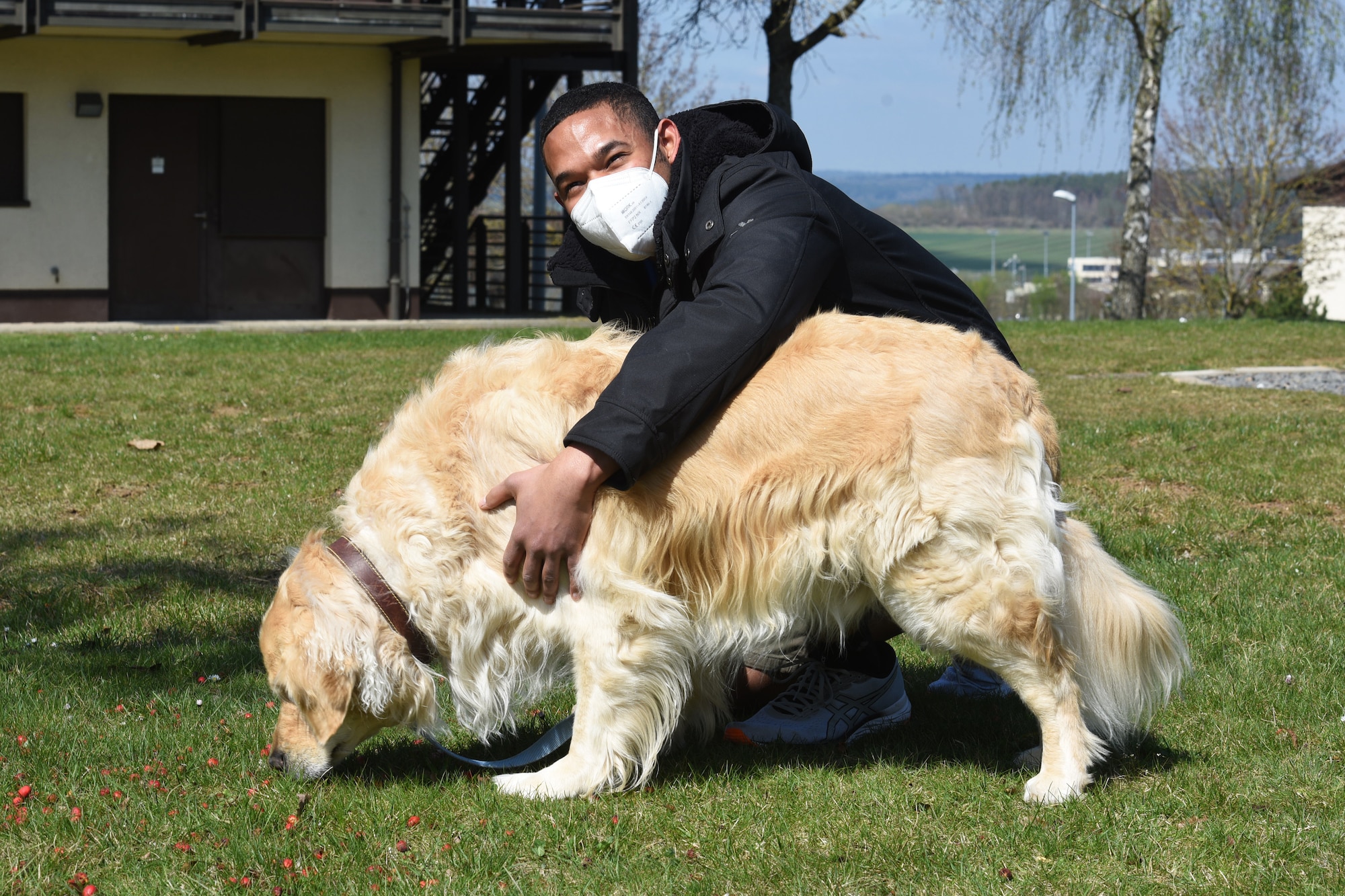 U.S. Air Force Senior Airman Robin Cepeda Santos a dormitory resident pets Max, one of the two dogs who make up Dogs in the Dorms, at Spangdahlem Air Base, Germany, April 2, 2021. The program kicked off in April and currently has two dogs who participate. (U.S. Air Force photo by Tech. Sergeant Tony Plyler)