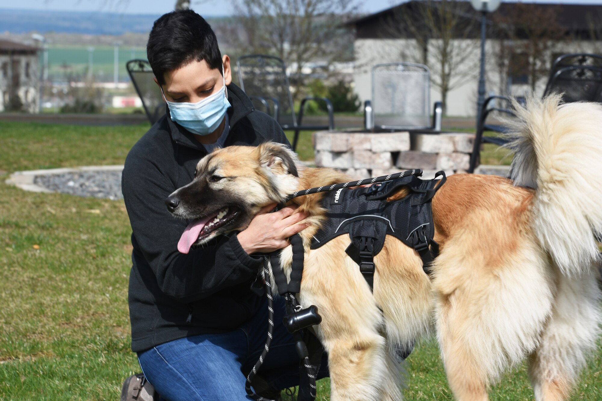 U.S. Air Force Capt. Milagros Gargurevich, 52nd Medical Group clinical psychologist pets her dog Remi at Spangdahlem Air Base, Germany, April 2, 2021. Gargurevich and Remi both assist with the Dogs in the Dorms program, which is designed to provide junior enlisted members stress relief and boost morale by allowing them an opportunity to pet and walk the dogs. (U.S. Air Force photo by Tech. Sergeant Tony Plyler)