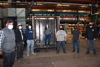 Employees of Norfolk Naval Shipyard’s Metal Inspectors Division (Code 135), shipfitting shop (Shop 11) and welding shop (Shop 26) stand by one of their newest welding mock up pieces. These pieces are used to help train, develop and simulate real life welding and inspection scenarios.