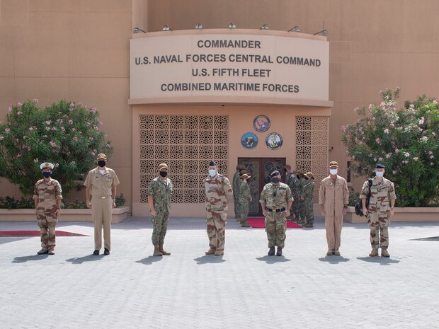 210401-N-KZ419-1004 NAVAL SUPPORT ACTIVITY BAHRAIN (April 1, 2021) – Vice Adm. Samuel Paparo, commander of U.S. Naval Forces Central Command (NAVCENT), U.S. 5th Fleet and Combined Maritime Forces, third from left, and French Armed Forces Chief of Joint Operations Lt. Gen. Stephane Mille, center, pose for a photo in front of NAVCENT during Mille’s visit to NAVCENT headquarters onboard Naval Support Activity Bahrain, April 1. NAVCENT is the U.S. Navy element of U.S. Central Command in the U.S. 5th Fleet area of operations and encompasses about 2.5 million square miles of water area and includes the Arabian Gulf, Gulf of Oman, Red Sea and parts of the Indian Ocean. The expanse is comprised of 20 countries and includes three critical choke points at the Strait of Hormuz, the Suez Canal and the Strait of Bab al Mandeb at the southern tip of Yemen. (U.S. Navy photo by Mass Communication Specialist 3rd Class Dawson Roth)