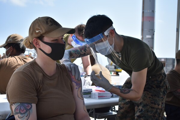 OKINAWA, Japan (Mar. 16, 2021) Boatswain’s Mate 2nd Class Anjellica Beyner, from Kissimmee, Fla., assigned to the amphibious dock landing ship USS Germantown (LSD 42), receives the second dose of the Moderna COVID-19 vaccine. Germantown, part of Amphibious Squadron 11, along with the 31st Marine Expeditionary Unit, is operating in the U.S. 7th Fleet area of responsibility to enhance interoperability with allies and partners and serve as a ready response force to defend peace and stability in the Indo-Pacific region. (U.S. Navy photo by Lt. j.g. Yeltsin E. Rodriguez)