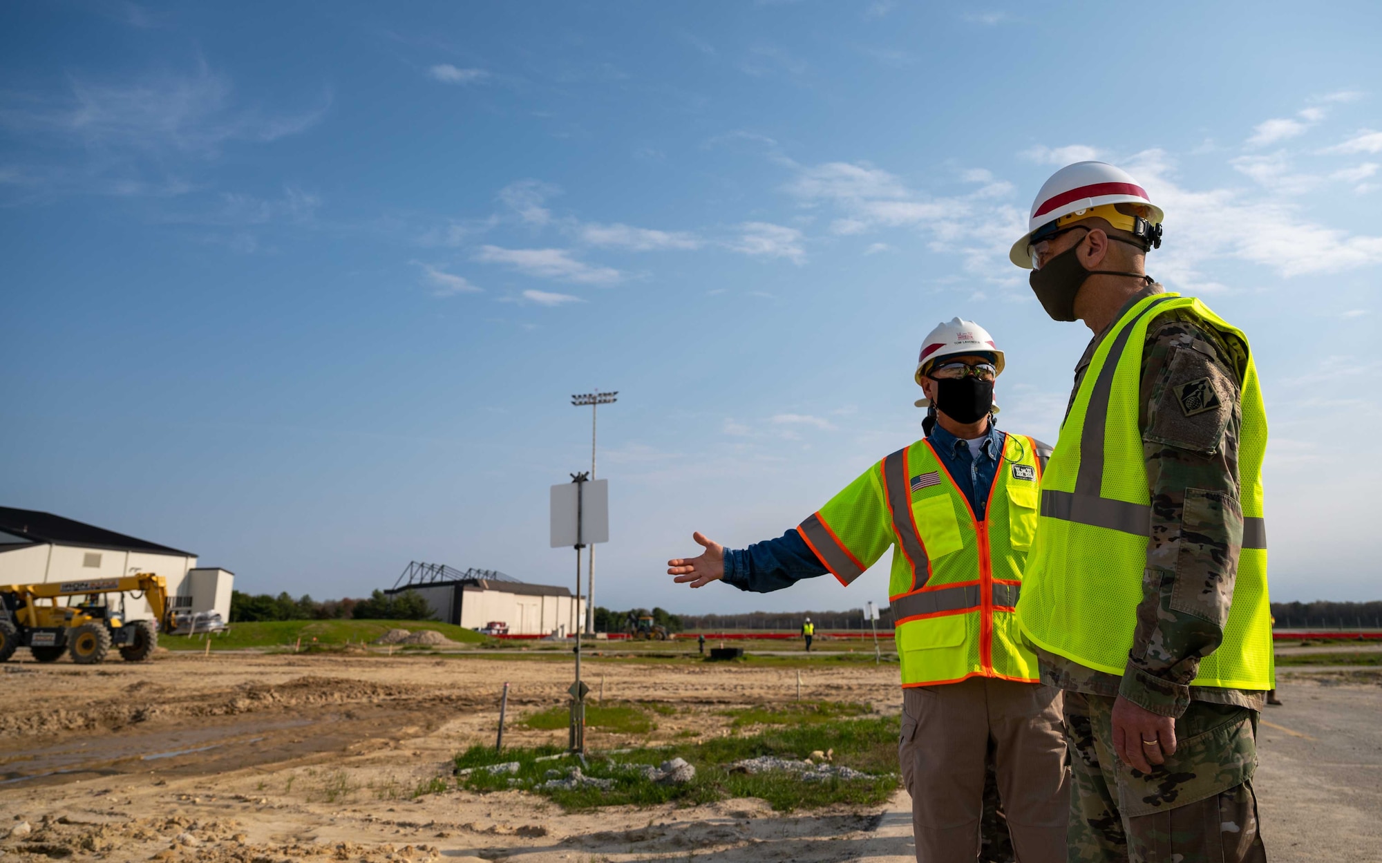 Tom Lavender, U.S. Army Corps of Engineers  project manager at the Dover Air Force Base office, discusses aircraft hangar construction with U.S. Army Lt. Gen. Scott A. Spellmon, 55th Chief of Engineers, U.S. Army Corps of Engineers commanding general, at Dover AFB, Delaware, April 7, 2021. During his visit, Spellmon toured facilities under construction management by the Corps. The new $41.2 million aircraft hangar will be the first hangar built on Dover AFB since 1983 and will house the C-5M Super Galaxy, the largest aircraft in the U.S. Air Force inventory. (U.S. Air Force photo by Airman 1st Class Faith Schaefer)