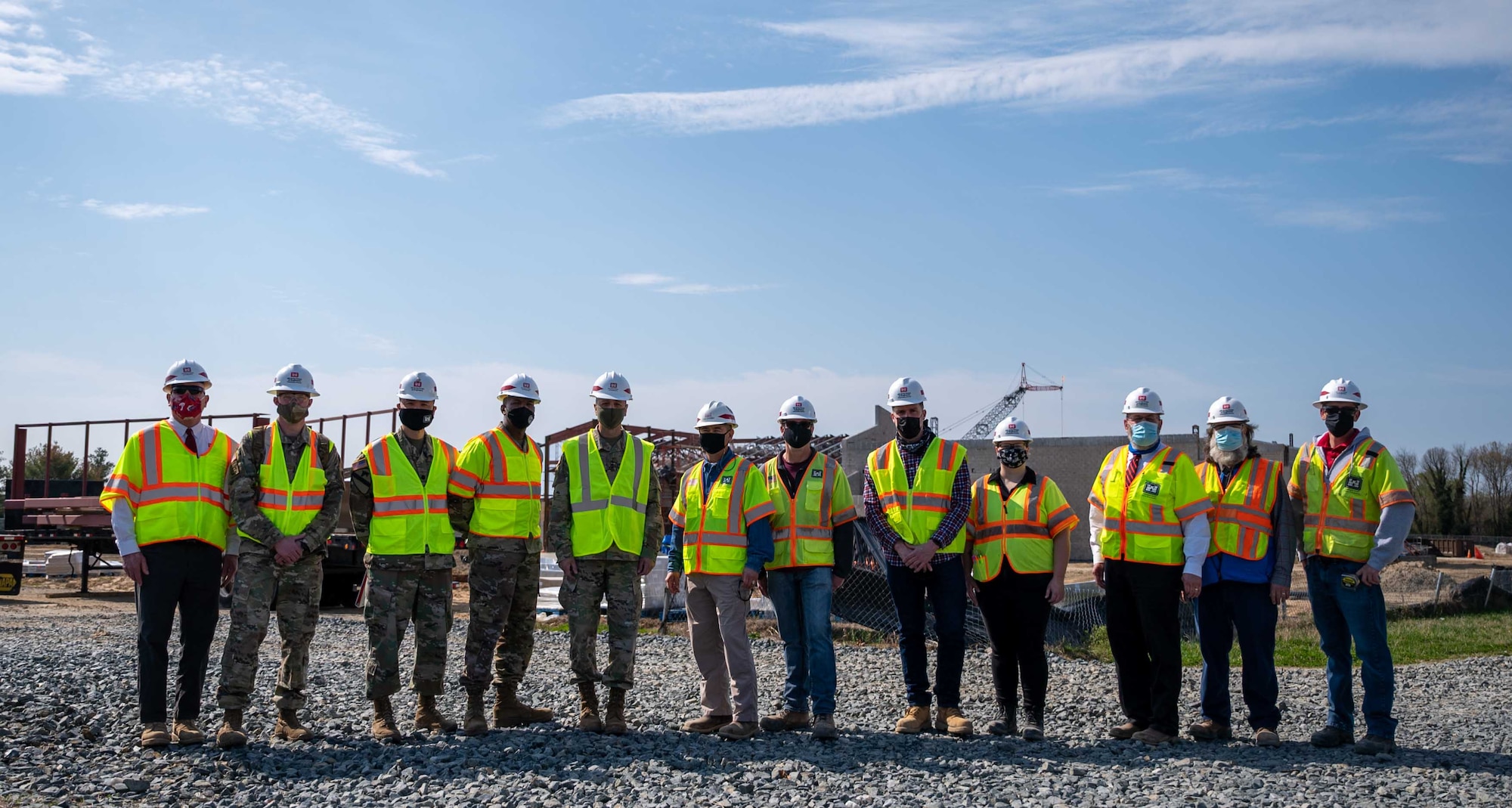 U.S. Army Corps of Engineers Dover Air Force Base military construction team members pose for a photo in front of the school construction site with U.S. Army Lt. Gen. Scott A. Spellmon, 55th Chief of Engineers, U.S. Army Corps of Engineers commanding general, on Dover AFB, Delaware, April 7, 2021. During a base visit, Spellmon toured facilities under construction management by the Corps. The $48 million school in base housing will replace the current Welch Elementary and Dover AFB Middle Schools. (U.S. Air Force photo by Airman 1st Class Faith Schaefer)