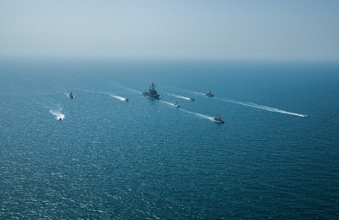 Royal Bahrain Naval Force fast attack craft RBNS Abdul Rahman Al-fadel (P 22), Bahrain Coast Guard response boats Hawar 5 and Hawar 4, U.S. Navy guided-missile destroyer USS Mahan (DDG 72), patrol coastal ships USS Squall (PC 7) and USS Hurricane (PC 3), U.S. Coast Guard patrol boat USCGC Adak (WBP 1333) and two Mark VI patrol boats operate in formation during exercise Neon Defender in the Arabian Gulf, April 7. Neon Defender 21 is a bilateral maritime exercise between the U.S. and Bahrain, designed to enhance interoperability and readiness, fortify military-to-military relationships and advance operational capabilities, allowing participating naval forces to effectively develop the necessary skills to address threats to regional security, freedom of navigation and the free flow of commerce. (Army Photo by Spc. Evens Milcette Jr.)