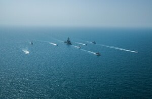 Royal Bahrain Naval Force fast attack craft RBNS Abdul Rahman Al-fadel (P 22), Bahrain Coast Guard response boats Hawar 5 and Hawar 4, U.S. Navy guided-missile destroyer USS Mahan (DDG 72), patrol coastal ships USS Squall (PC 7) and USS Hurricane (PC 3), U.S. Coast Guard patrol boat USCGC Adak (WBP 1333) and two Mark VI patrol boats operate in formation during exercise Neon Defender in the Arabian Gulf, April 7. Neon Defender 21 is a bilateral maritime exercise between the U.S. and Bahrain, designed to enhance interoperability and readiness, fortify military-to-military relationships and advance operational capabilities, allowing participating naval forces to effectively develop the necessary skills to address threats to regional security, freedom of navigation and the free flow of commerce. (Army Photo by Spc. Evens Milcette Jr.)