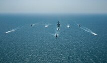 Royal Bahrain Naval Force fast attack craft RBNS Abdul Rahman Al-fadel (P 22), Bahrain Coast Guard response boats Hawar 5 and Hawar 4, U.S. Navy guided-missile destroyer USS Mahan (DDG 72), patrol coastal ships USS Squall (PC 7) and USS Hurricane (PC 3), U.S. Coast Guard patrol boat USCGC Adak (WBP 1333) and two Mark VI patrol boats operate in formation during exercise Neon Defender in the Arabian Gulf, April 7. Neon Defender 21 is a bilateral maritime exercise between the U.S. and Bahrain, designed to enhance interoperability and readiness, fortify military-to-military relationships and advance operational capabilities, allowing participating naval forces to effectively develop the necessary skills to address threats to regional security, freedom of navigation and the free flow of commerce. (Army Photo by Spc. Evens Milcette Jr.)