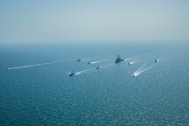 Royal Bahrain Naval Force fast attack craft RBNS Abdul Rahman Al-fadel (P 22), Bahrain Coast Guard response boats Hawar 5 and Hawar 4, U.S. Navy guided-missile destroyer USS Mahan (DDG 72), patrol coastal ships USS Squall (PC 7) and USS Hurricane (PC 3), U.S. Coast Guard patrol boat USCGC Adak (WBP 1333) and two Mark VI patrol boats operate in formation during exercise Neon Defender in the Arabian Gulf, April 7. Neon Defender 21 is a bilateral maritime exercise between the U.S. and Bahrain, designed to enhance interoperability and readiness, fortify military-to-military relationships and advance operational capabilities, allowing participating naval forces to effectively develop the necessary skills to address threats to regional security, freedom of navigation and the free flow of commerce. (Army Photo by Spc. Evens Milcette Jr.)