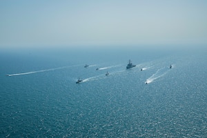 Royal Bahrain Naval Force fast attack craft RBNS Abdul Rahman Al-fadel (P 22), Bahrain Coast Guard response boats Hawar 5 and Hawar 4, U.S. Navy guided-missile destroyer USS Mahan (DDG 72), patrol coastal ships USS Squall (PC 7) and USS Hurricane (PC 3), U.S. Coast Guard patrol boat USCGC Adak (WBP 1333) and two Mark VI patrol boats operate in formation during exercise Neon Defender in the Arabian Gulf, April 7. Neon Defender 21 is a bilateral maritime exercise between the U.S. and Bahrain, designed to enhance interoperability and readiness, fortify military-to-military relationships and advance operational capabilities, allowing participating naval forces to effectively develop the necessary skills to address threats to regional security, freedom of navigation and the free flow of commerce. (Army Photo by Spc. Evens Milcette Jr.)