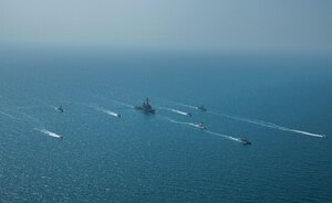 Royal Bahrain Naval Force fast attack craft RBNS Abdul Rahman Al-fadel (P 22), Bahrain Coast Guard response boats Hawar 5 and Hawar 4, U.S. Navy guided-missile destroyer USS Mahan (DDG 72), patrol coastal ships USS Squall (PC 7) and USS Hurricane (PC 3), U.S. Coast Guard patrol boat USCGC Adak (WBP 1333) and two Mark VI patrol boats operate in formation during exercise Neon Defender in the Arabian Gulf, April 7. Neon Defender 21 is a bilateral maritime exercise between the U.S. and Bahrain, designed to enhance interoperability and readiness, fortify military-to-military relationships and advance operational capabilities, allowing participating naval forces to effectively develop the necessary skills to address threats to regional security, freedom of navigation and the free flow of commerce. (Army Photo by Spc. Evens Milcette Jr.)