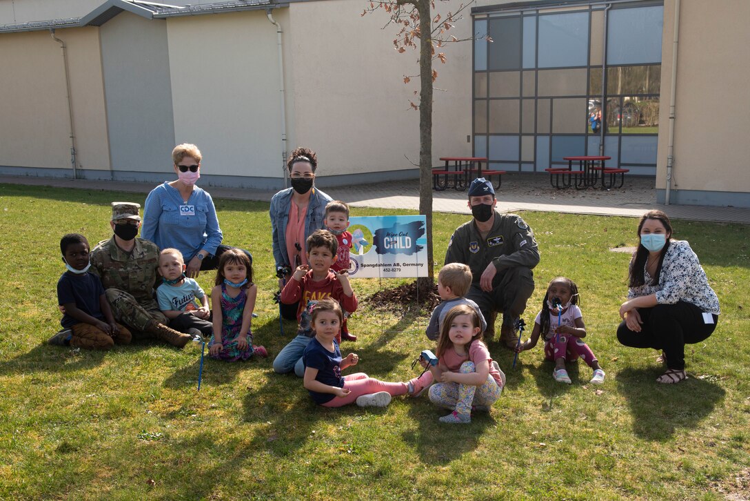 52nd Fighter Wing leadership and Family Advocacy members  pose for a photo with children from the Child Development Center on Spangdahlem Air Base, Germany, April 1, 2021. The Family Advocacy program on base has programs that aid in treating, educating and preventing child abuse and neglect. (U.S. Air Force photo by Senior Airman Melody W. Howley)