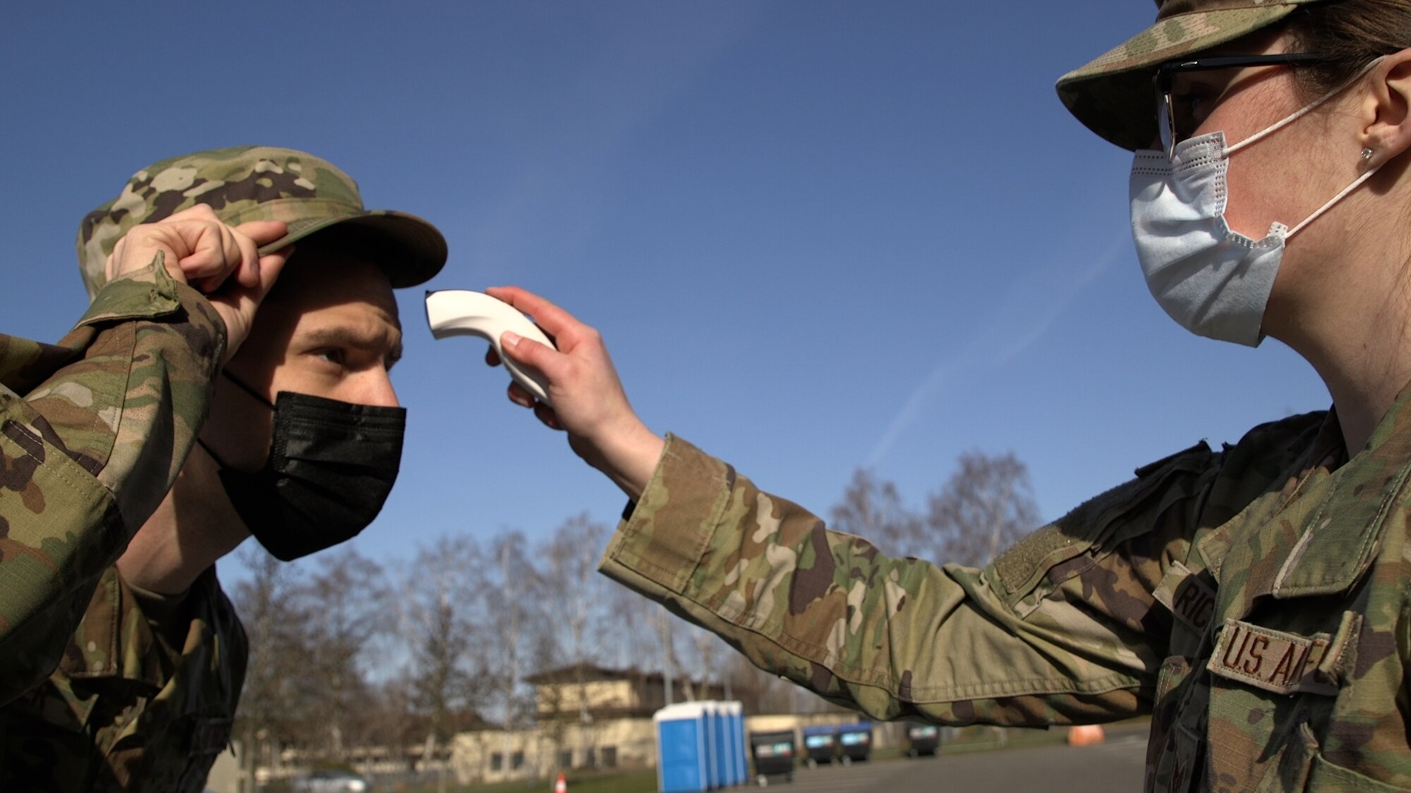 U.S. Air Force Staff Sgt. Misty Richmond, 52nd Medical Group Public Health technician (right), takes the temperature of U.S. Air Force Airman 1st Class Jordan Bulmer, 52nd Medical Group Public Health technician, at Spangdahlem Air Base Germany, March 29, 2021. The Public Health office is split into two different sections. One section, Force Health Management, is responsible for programs that deal with deployments, temporary duty assignments, occupational environmental health, and travel medicine. (U.S. Air Force photo by Tech. Sgt. Warren D. Spearman Jr.)