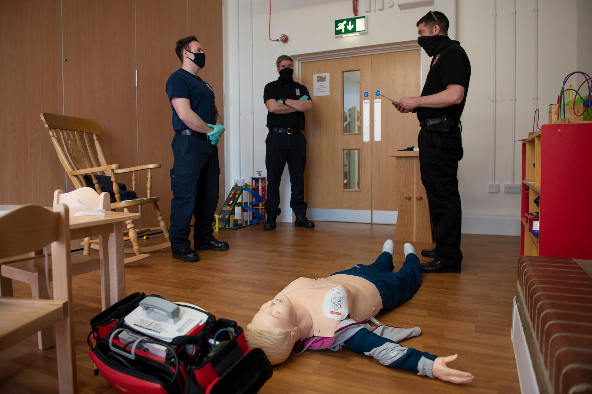 Tom Reynolds, left, 423rd Civil Engineer Squadron firefighter, prepares to perform CPR and automated external defibrillator assessment on a simulated patient during an EMT practical application exam at Royal Air Force Croughton, England, March 31, 2021. U.K. firefighters across the 501st Combat Support Wing were tested in a practical application of their knowledge and skills, after attending over 280 hours of the U.S. National Registry of Emergency Medical Technicians course. The primary mission of the course was to prepare the fire department to respond to medical emergencies, as EMTs assume the responsibility of operating the ambulances and transporting patients to medical facilities. (U.S. Air Force photo by Senior Airman Jennifer Zima)