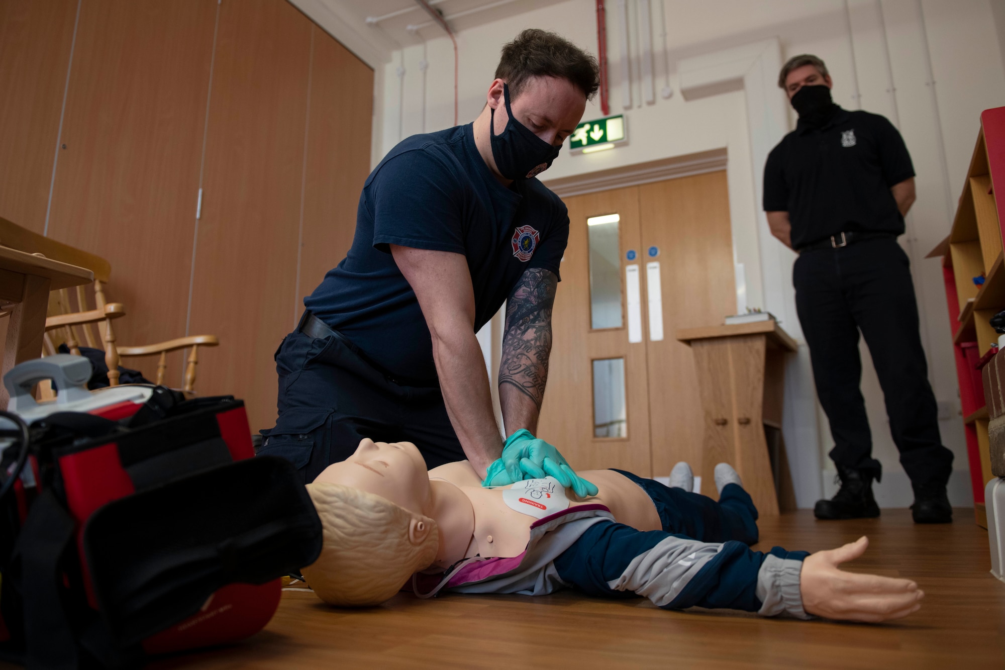 Tom Reynolds, left, 423rd Civil Engineer Squadron firefighter, conducts CPR on a simulated patient during an EMT practical application exam at Royal Air Force Croughton, England, March 31, 2021. U.K. firefighters across the 501st Combat Support Wing were tested in a practical application of their knowledge and skills, after attending over 280 hours of the U.S. National Registry of Emergency Medical Technicians course. The primary mission of the course was to prepare the fire department to respond to medical emergencies, as EMTs assume the responsibility of operating the ambulances and transporting patients to medical facilities. (U.S. Air Force photo by Senior Airman Jennifer Zima)
