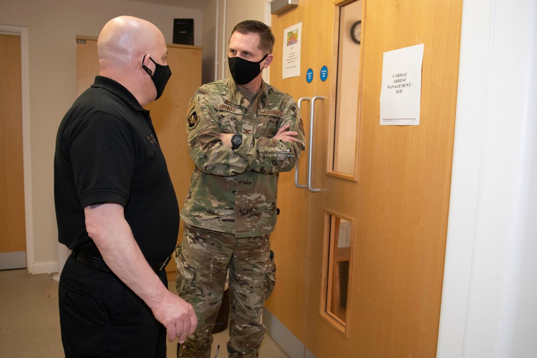 Keith Jimmo, left, 422nd Civil Engineer Squadron fire chief, discusses working with the counties’ ambulance services with U.S. Air Force Col. Jon Hannah, right, 422nd Air Base Group commander, during an EMT practical application exam at Royal Air Force Croughton, England, March 31, 2021. U.K. firefighters across the 501st Combat Support Wing were tested in a practical application of their knowledge and skills, after attending over 280 hours of the U.S. National Registry of Emergency Medical Technicians course. The primary mission of the course was to prepare the fire department to respond to medical emergencies, as EMTs assume the responsibility of operating the ambulances and transporting patients to medical facilities. (U.S. Air Force photo by Senior Airman Jennifer Zima)