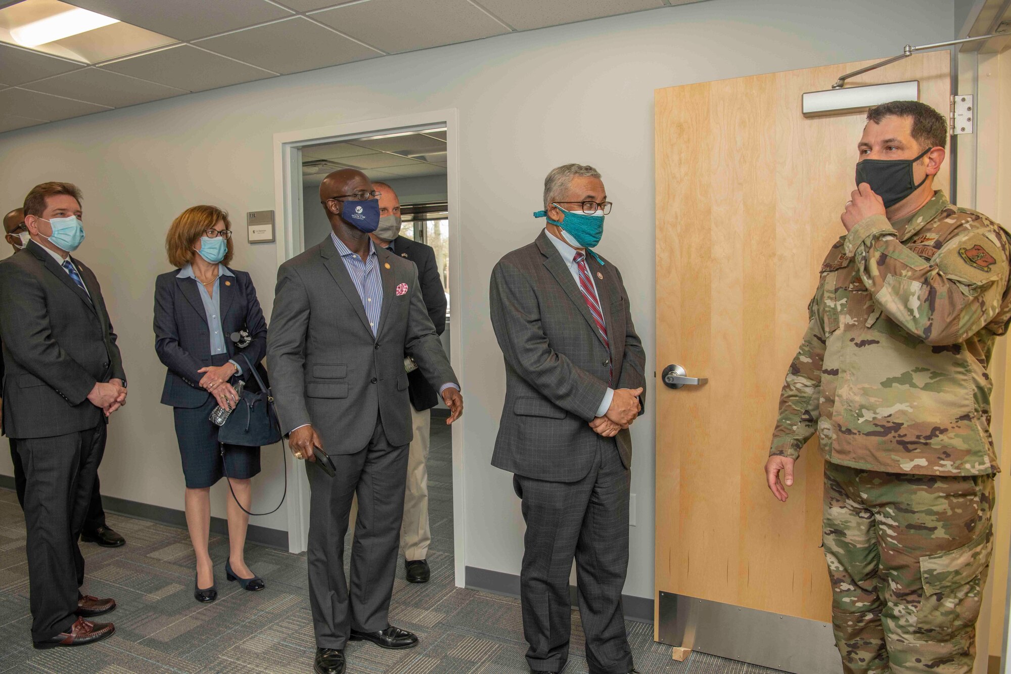 A U.S. Air Force commander guides state representatives on a tour