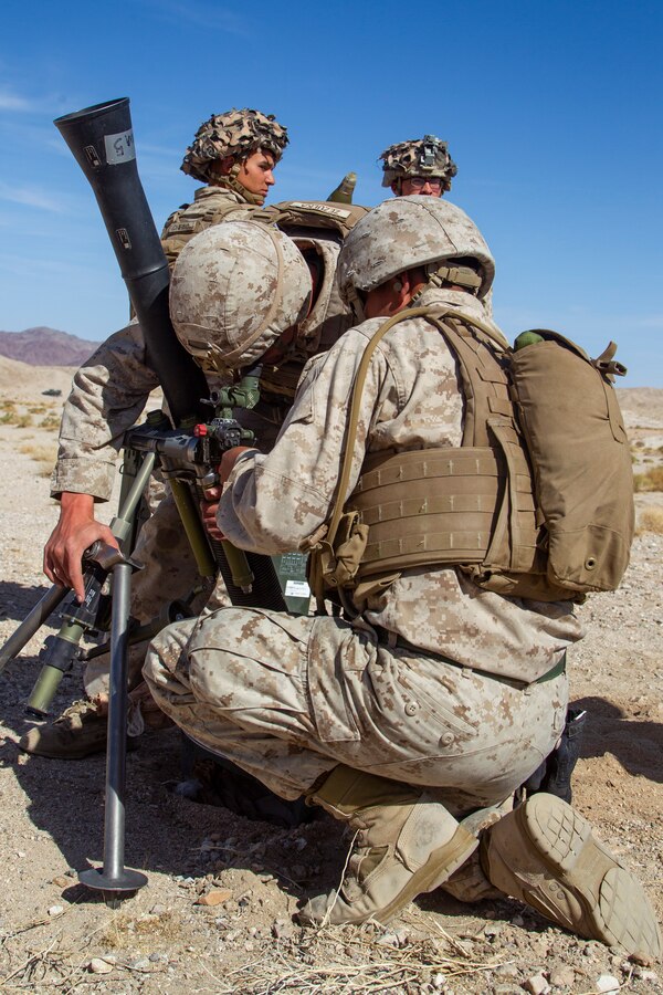 U.S. Marines with Weapons Company, 1st Battalion, 5th Marine Regiment prepare a M82A2 81 mm mortar round during Fire Support Coordination Exercise (FSCEX), a sub event of Integrated Training Exercise (ITX), 3-21 at Marine Corps Air Ground Combat Center, Twentynine Palms California, April 6, 2021. The purpose of ITX is to create a challenging, realistic training environment that produces combat-ready forces capable of operating as an integrated Marine Air Ground Task Force. (U.S. Marine Corps Photo by Lance Cpl. Jacquilyn Davis)