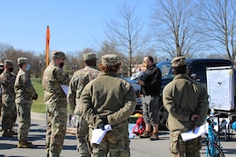 civilian man trains soldiers about bike safety