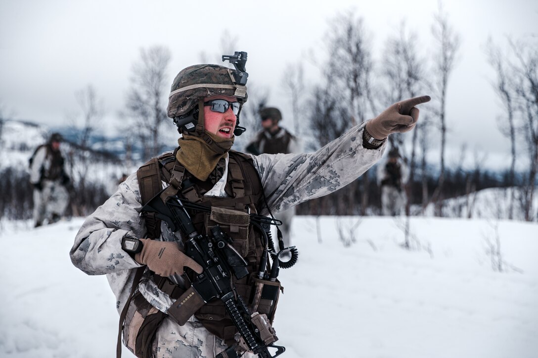 A U.S. Marine with Marine Rotational Force Europe 21.1 (MRF-E), Marine Forces Europe and Africa, communicates with Marines down range during a company live-fire attack as part of Exercise Arctic Littoral Strike in Blåtind, Norway, March 30, 2021. Exercise Arctic Littoral Strike improved MRF-E’s ability to confront the challenges of anti-access, area denial capabilities posed by a notional peer adversary in a contested littoral environment. MRF-E demonstrated the ability to support joint fleet operations by providing over watch to a Norwegian submarine and destroying a notional adversary integrated air defense system. MRF-E focuses on regional engagements throughout Europe by conducting various exercises, arctic cold-weather and mountain warfare training, and military-to-military engagements, which enhance overall interoperability of the U.S. Marine Corps with allies and partners. (U.S. Marine Corps photo by Cpl. Patrick King)
