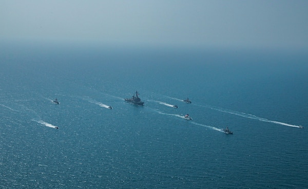 Royal Bahrain Naval Force fast attack craft RBNS Abdul Rahman Al-fadel (P 22), Bahrain Coast Guard response boats Hawar 5 and Hawar 4, U.S. Navy guided-missile destroyer USS Mahan (DDG 72), patrol coastal ships USS Squall (PC 7) and USS Hurricane (PC 3), U.S. Coast Guard patrol boat USCGC Adak (WBP 1333) and two Mark VI patrol boats operate in formation during exercise Neon Defender in the Arabian Gulf, April 7. Neon Defender 21 is a bilateral maritime exercise between the U.S. and Bahrain, designed to enhance interoperability and readiness, fortify military-to-military relationships and advance operational capabilities, allowing participating naval forces to effectively develop the necessary skills to address threats to regional security, freedom of navigation and the free flow of commerce. (Army Photo by Spc. Evens Milcette Jr.)