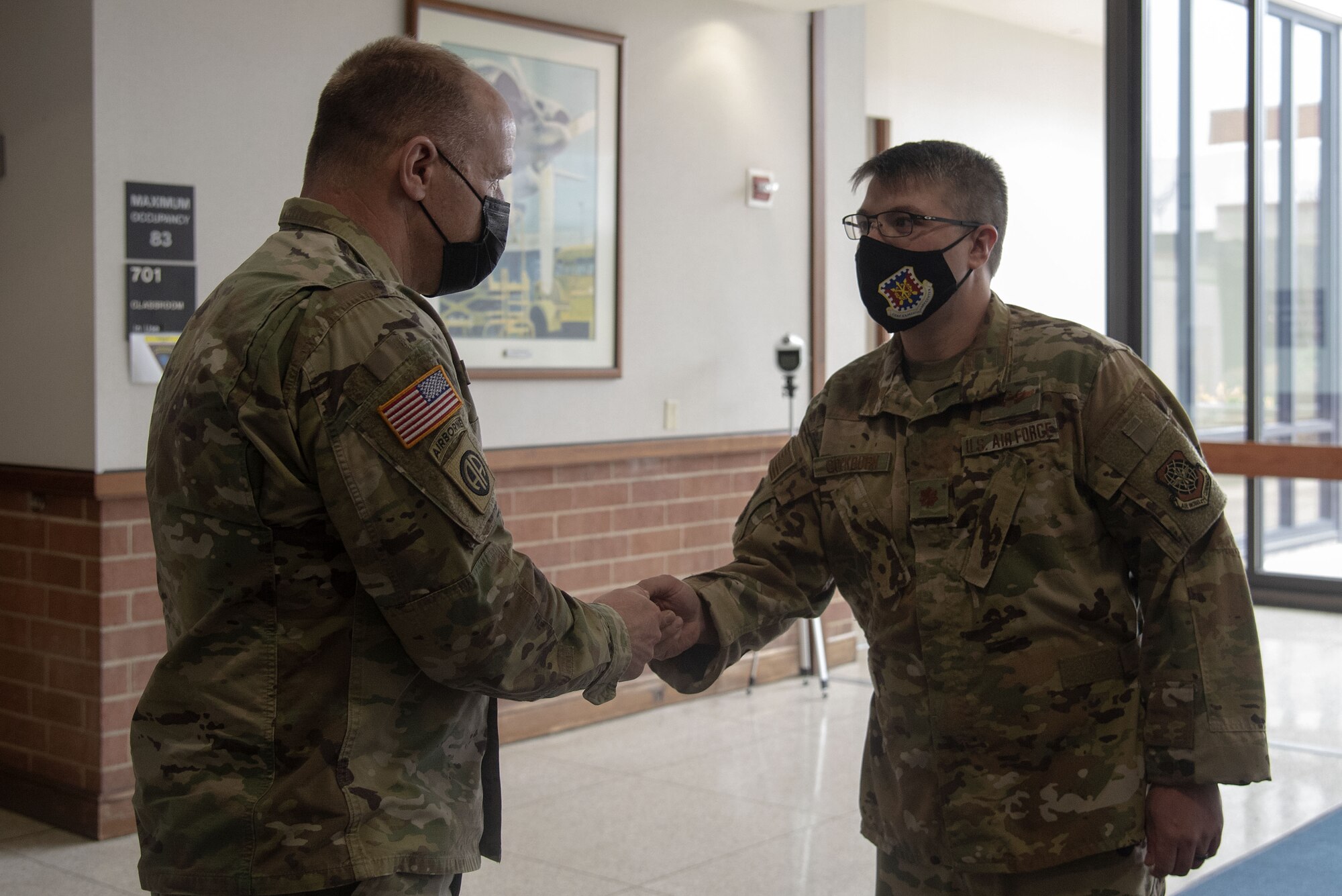Photo of Airmen receiving a challenge coin from Gen. Lyons